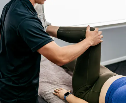 Practitioner providing hip rehabilitation treatment for femoroacetabular impingement