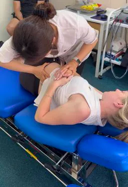 Chiropractor performing a manual spinal adjustment on a patient