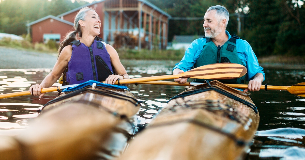 Mature Couple Has Fun Kayaking on lake