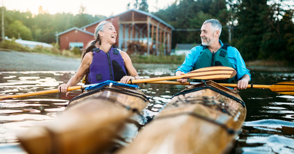Mature Couple Has Fun Kayaking on lake