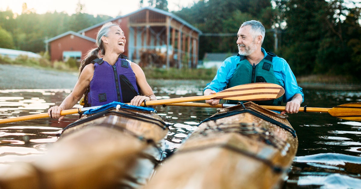 Mature Couple Has Fun Kayaking on lake