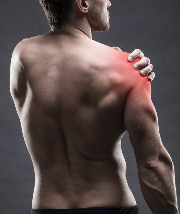 Pain in the shoulder. Muscular male body.