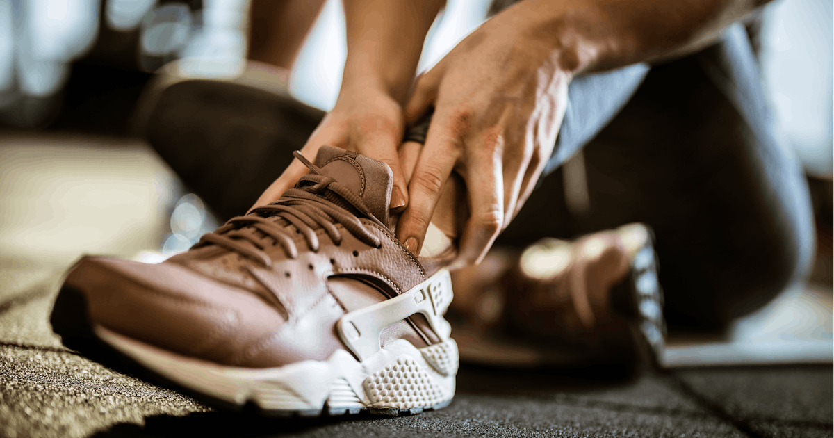 woman grabbing injured ankle