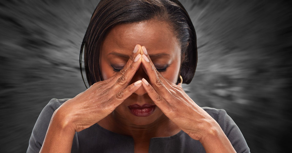 up close frontal black african american woman with both hands to head with headache pain migraine cervicogenic headache