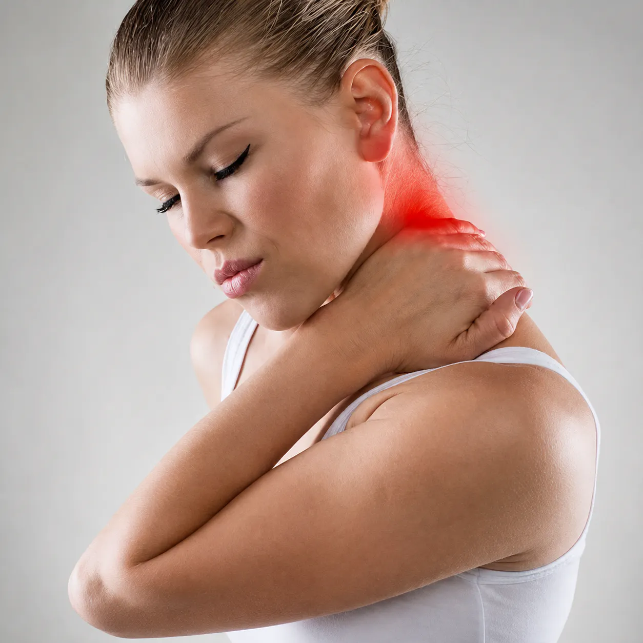 Woman holding her neck with cervical disc herniation pain and neck and shoulder discomfort