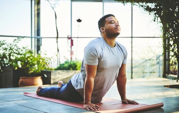 Young man practicing Upward Facing Dog Pose