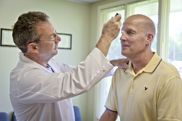 doctor examines patient