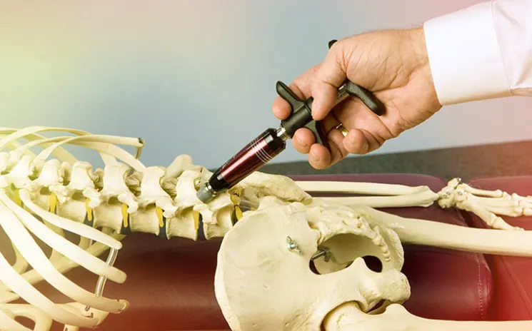 Activator Method chiropractic adjusting instrument being demonstrated on the cervical spine