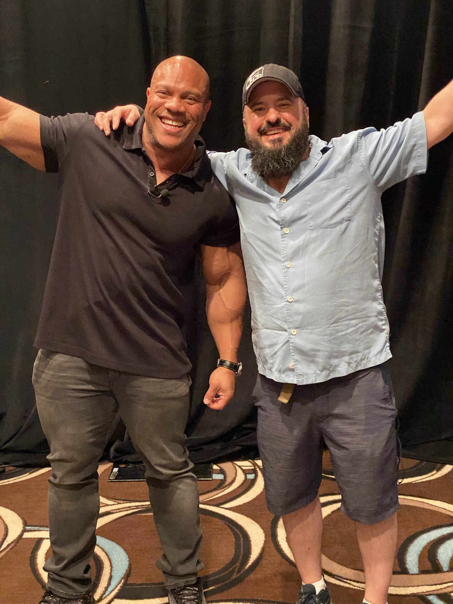 Two people posing together at a professional or community event
