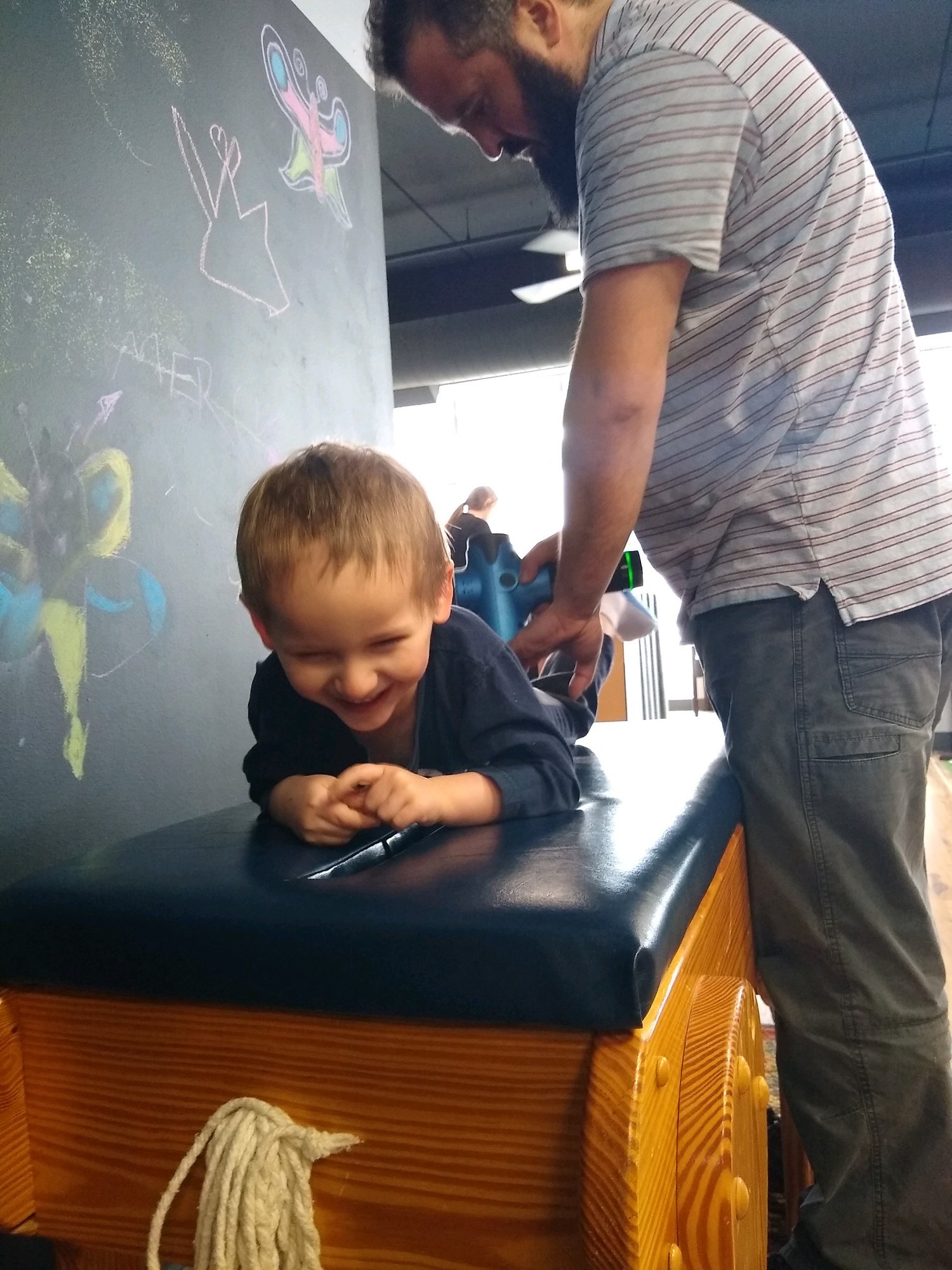 Child receiving care on a chiropractic treatment table