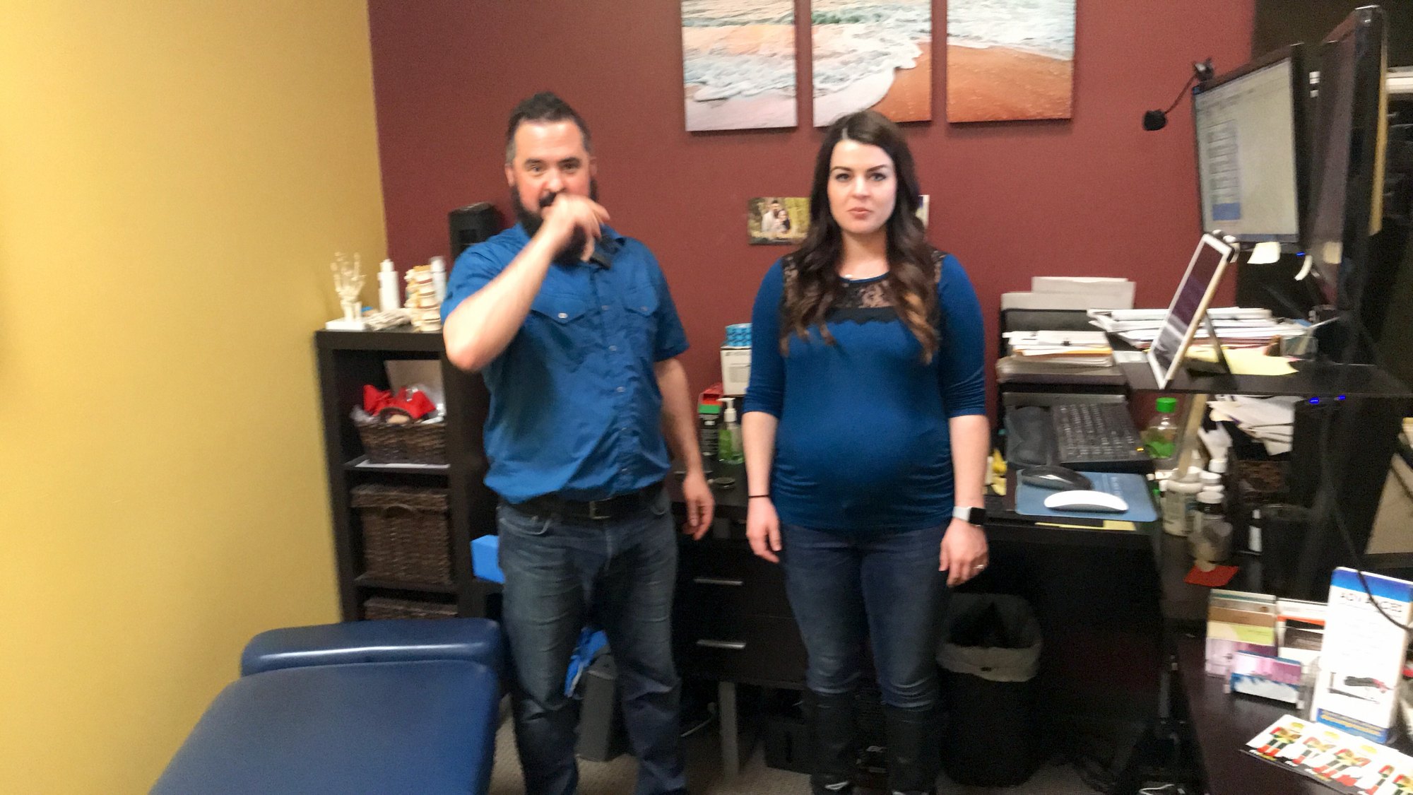 Clinician and patient standing together in a chiropractic treatment room