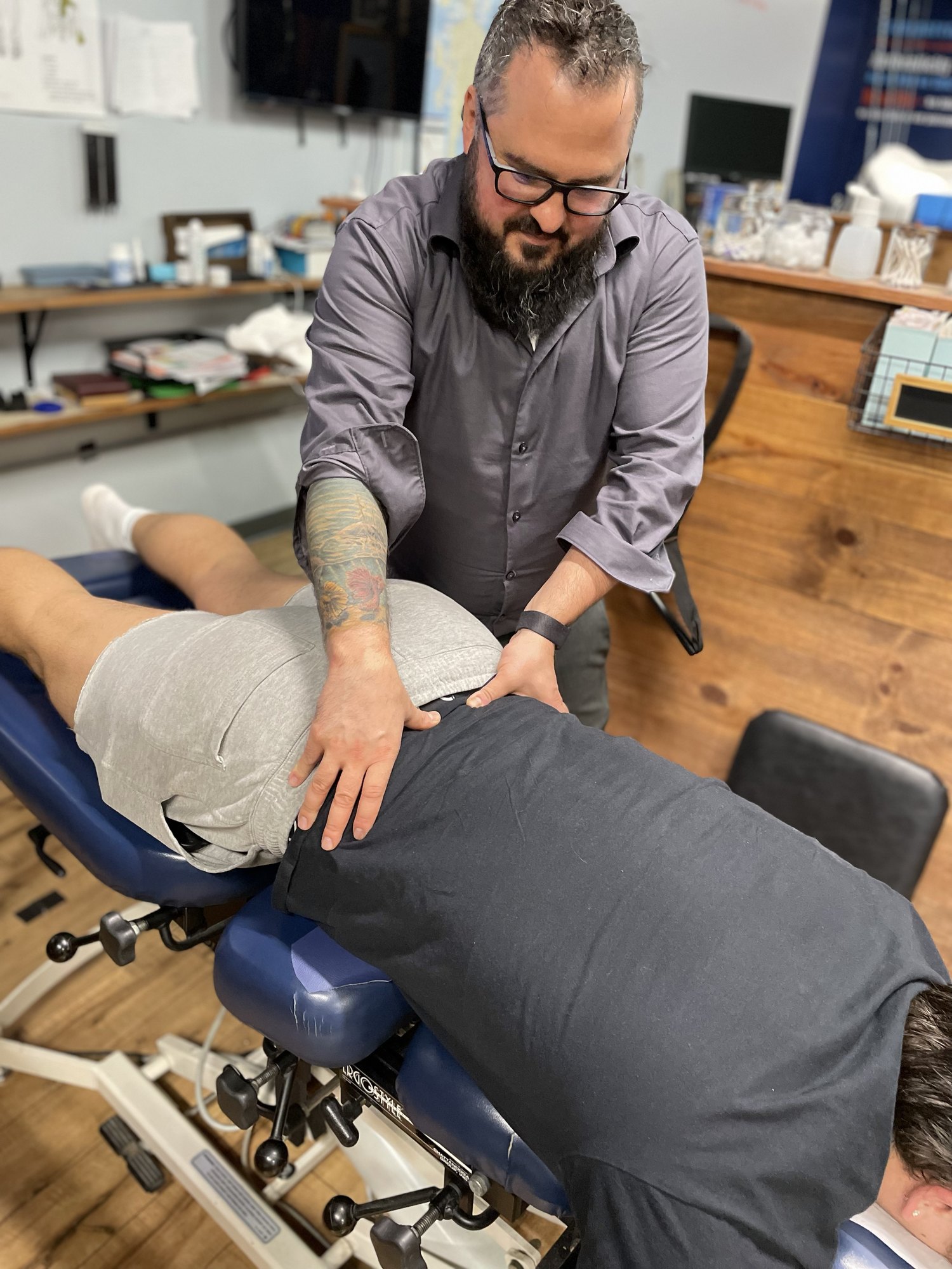 Chiropractic treatment being provided to a patient lying face down on a treatment table at Boundless