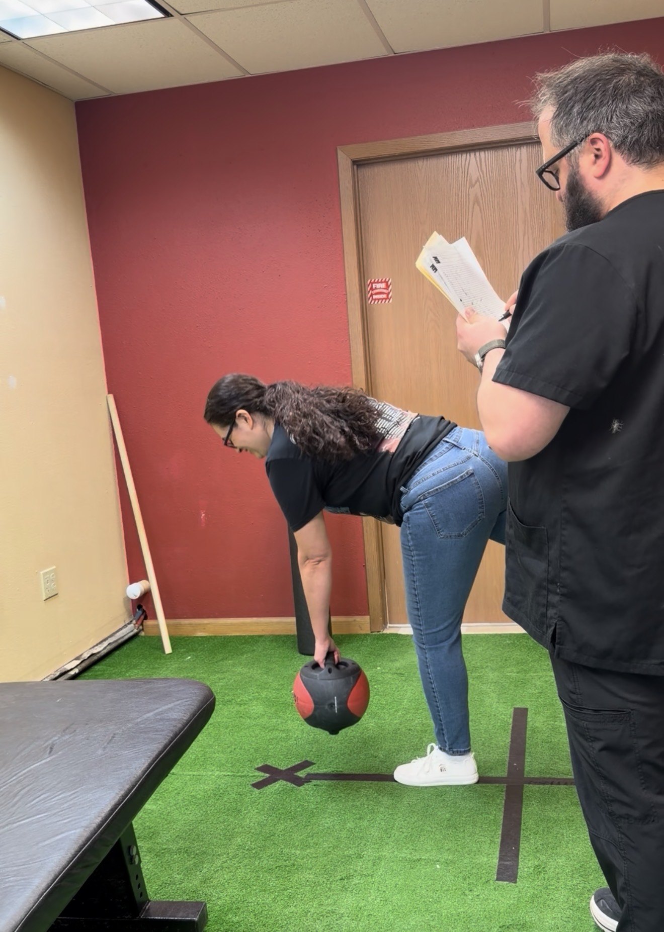 Patient performing a kettlebell movement assessment during rehabilitation at Boundless