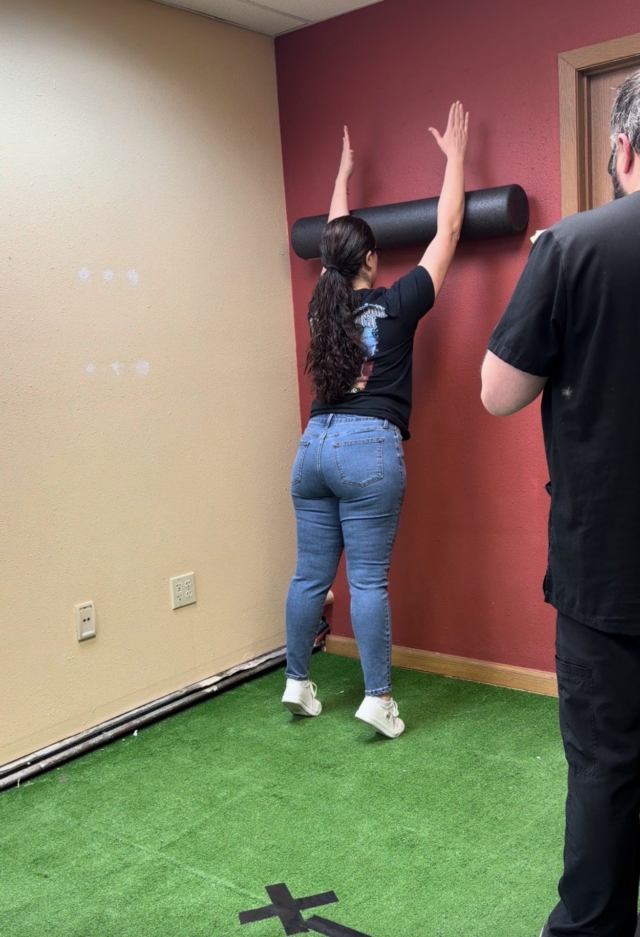 Patient completing a wall mobility assessment during rehabilitation at Boundless