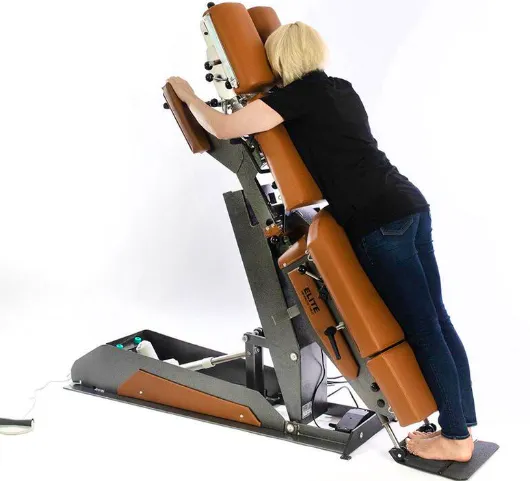 Patient using Elite knee-chest flexion-distraction chiropractic table