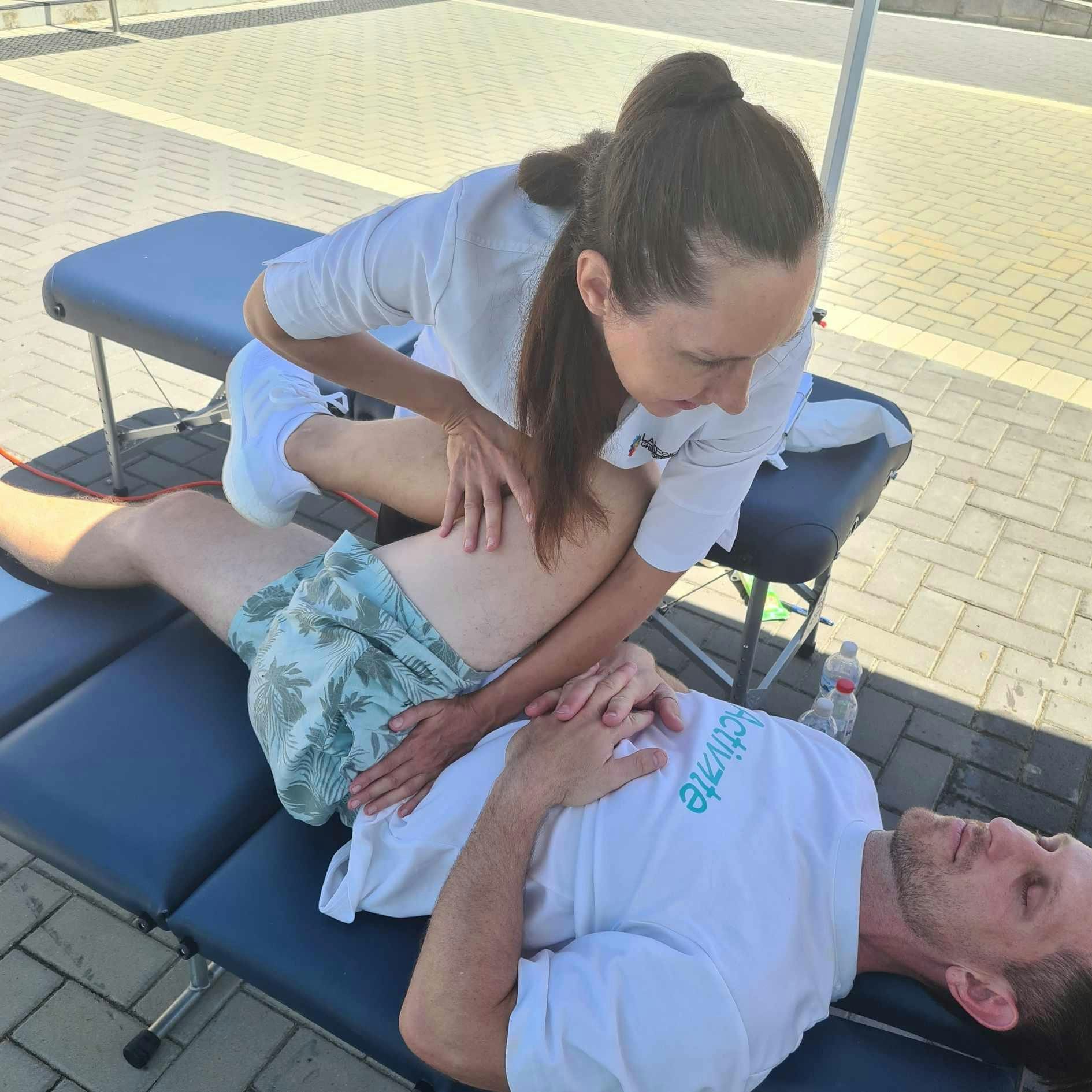 Dr. Linda Schiller providing chiropractic care to athlete at FitSpot event in Joondalup